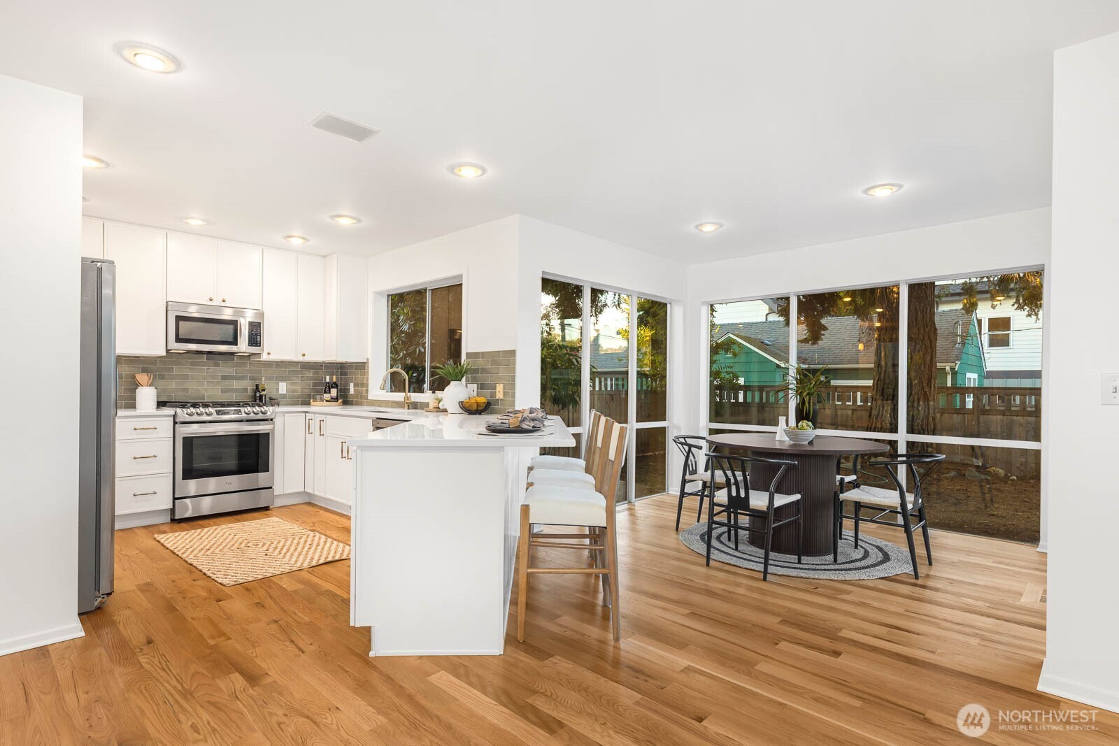 4922 Southwest Hudson Street Seattle, WA 98116 - Photo 12 of 37 a kitchen with a sink a counter top space and stainless steel appliances