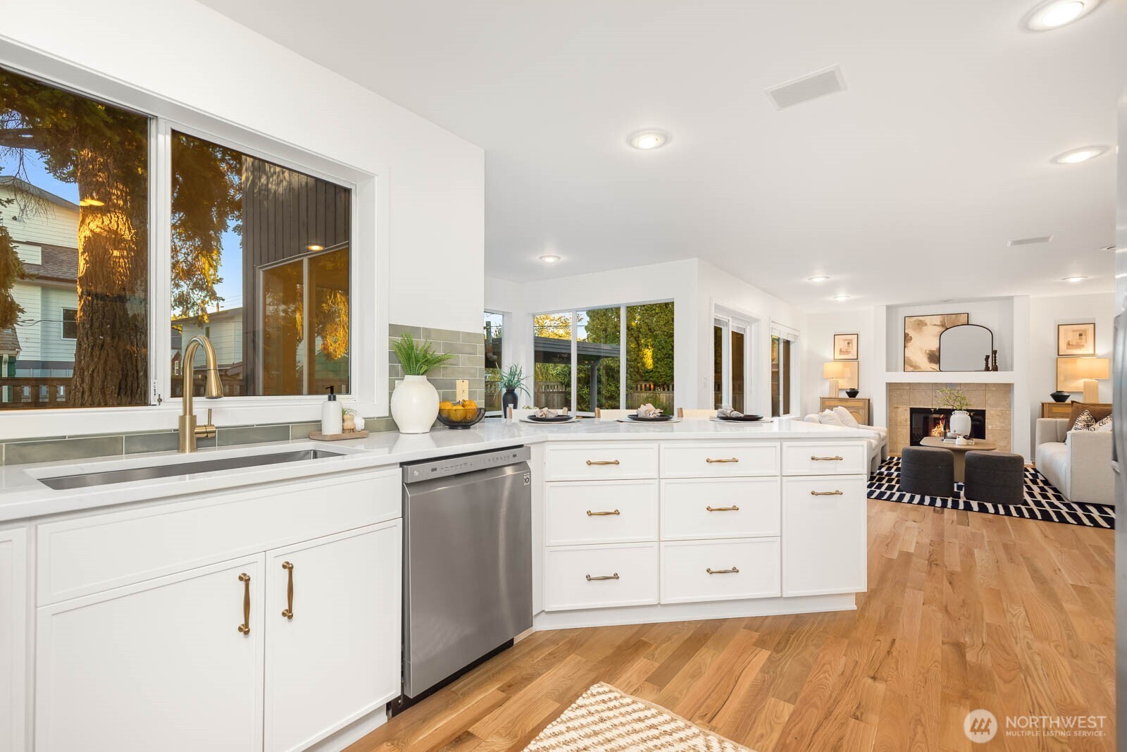4922 Southwest Hudson Street Seattle, WA 98116 - Photo 13 of 37 a view of a kitchen counter space with wooden floor and stainless steel appliances