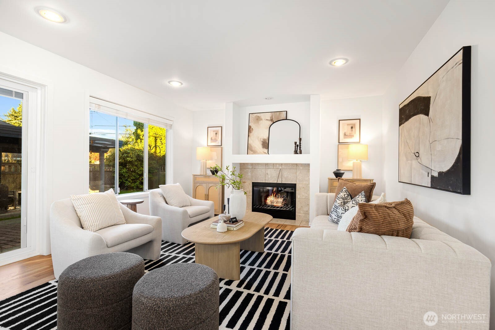 4922 Southwest Hudson Street Seattle, WA 98116 - Photo 17 of 37 a living room with furniture a large window and a fireplace