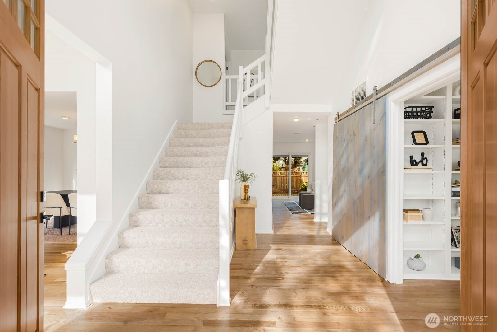 4922 Southwest Hudson Street Seattle, WA 98116 - Photo 3 of 37 a view of a hallway with white walls and stairs
