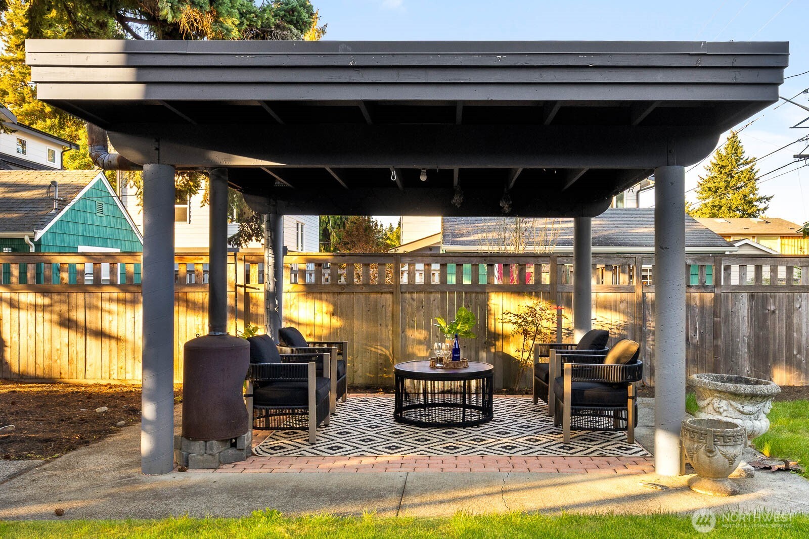 4922 Southwest Hudson Street Seattle, WA 98116 - Photo 31 of 37 a living room with fireplace furniture and a floor to ceiling window