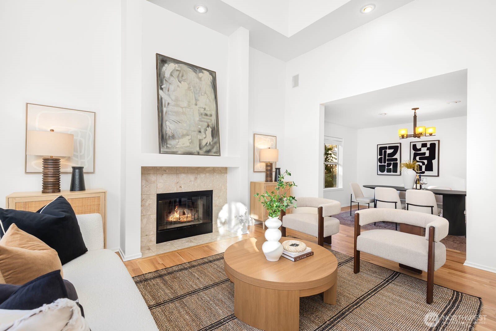 4922 Southwest Hudson Street Seattle, WA 98116 - Photo 6 of 37 a living room with furniture a table and a fireplace
