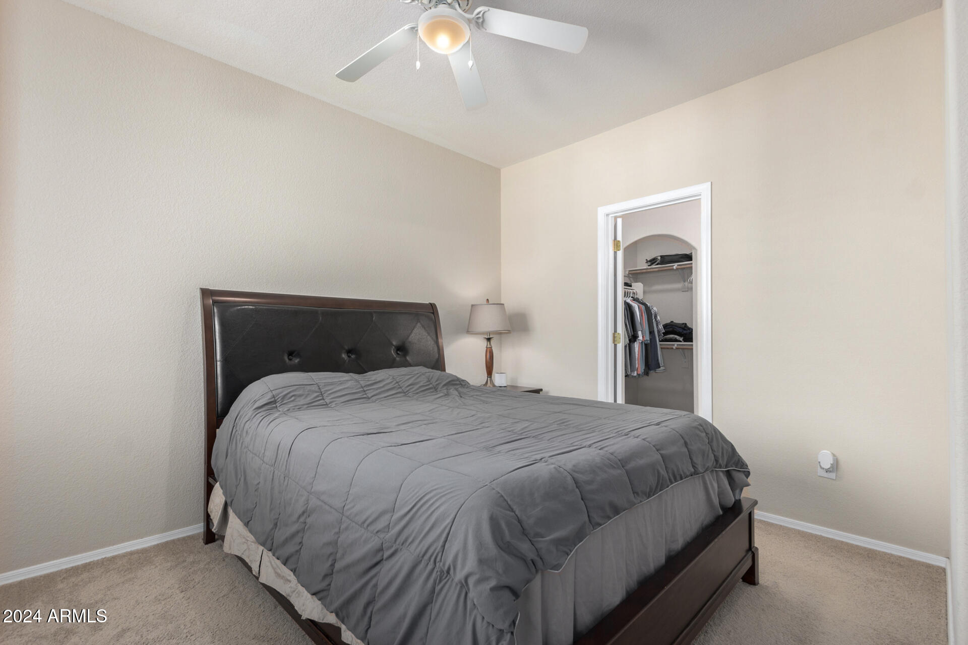 18250 North Cave Creek Road, Unit 163 Phoenix, AZ 85032 - Photo 13 of 32 a bedroom with a bed and a chandelier