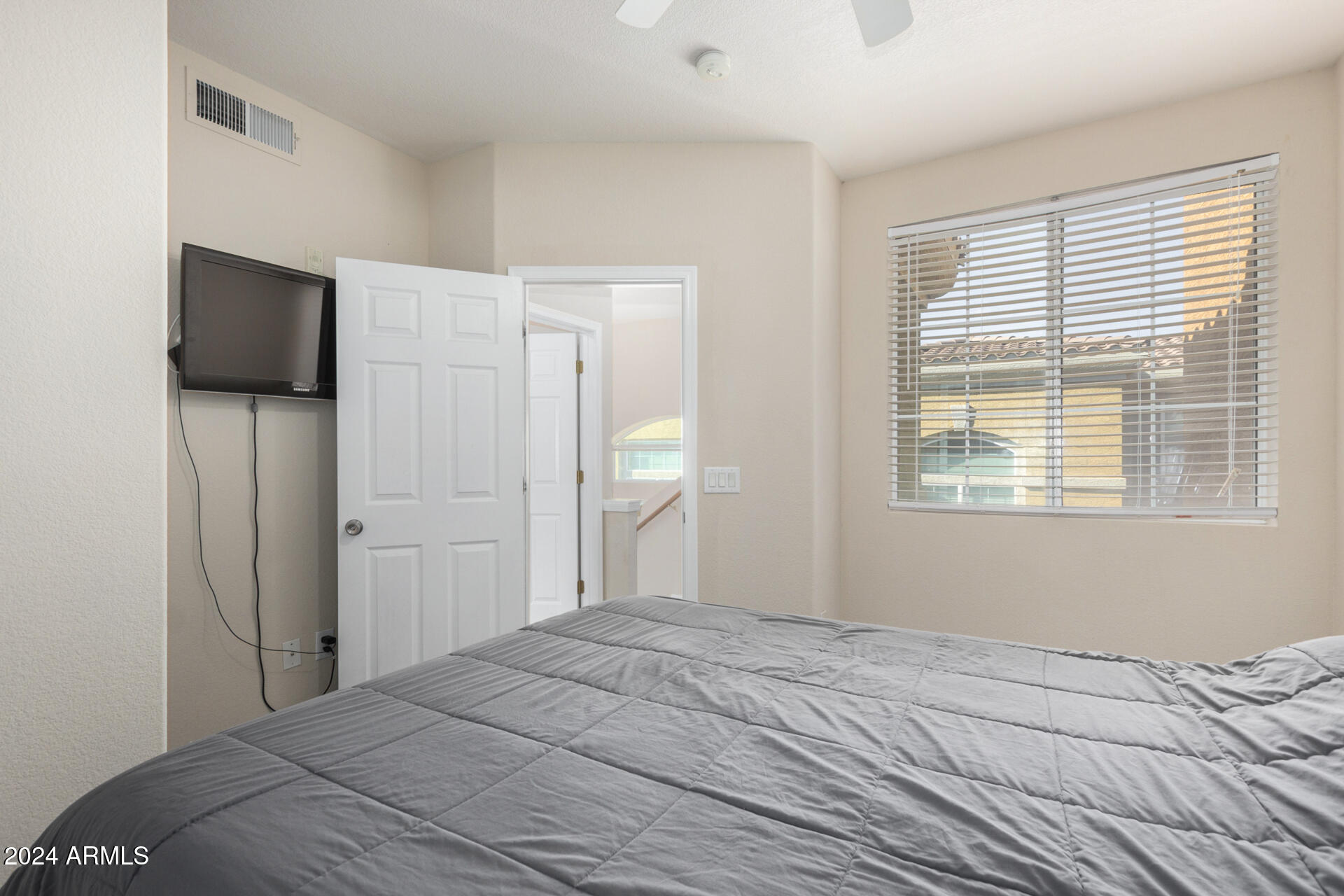 18250 North Cave Creek Road, Unit 163 Phoenix, AZ 85032 - Photo 14 of 32 a bedroom with a bed and a television