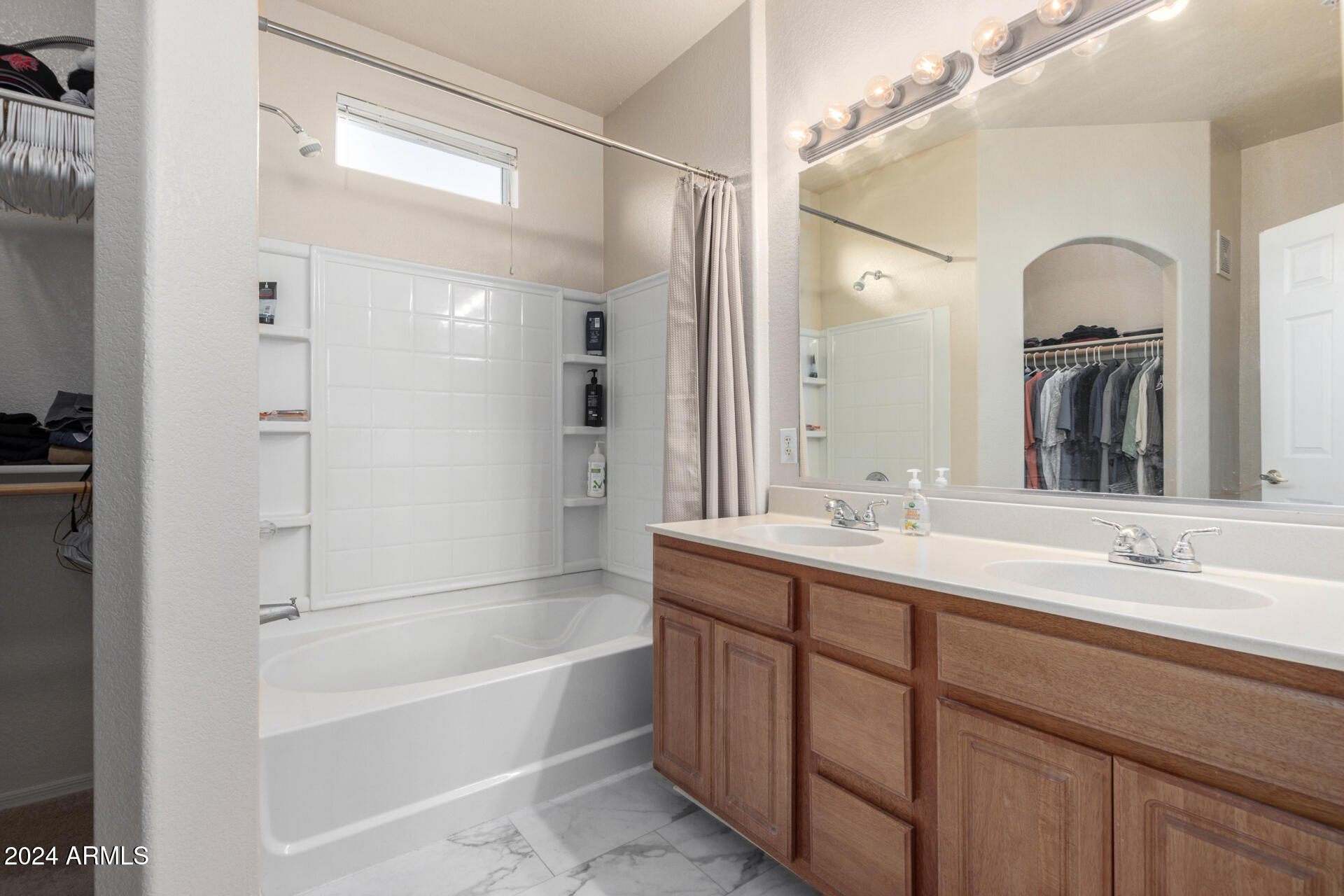 18250 North Cave Creek Road, Unit 163 Phoenix, AZ 85032 - Photo 15 of 32 a bathroom with a tub a sink and mirror