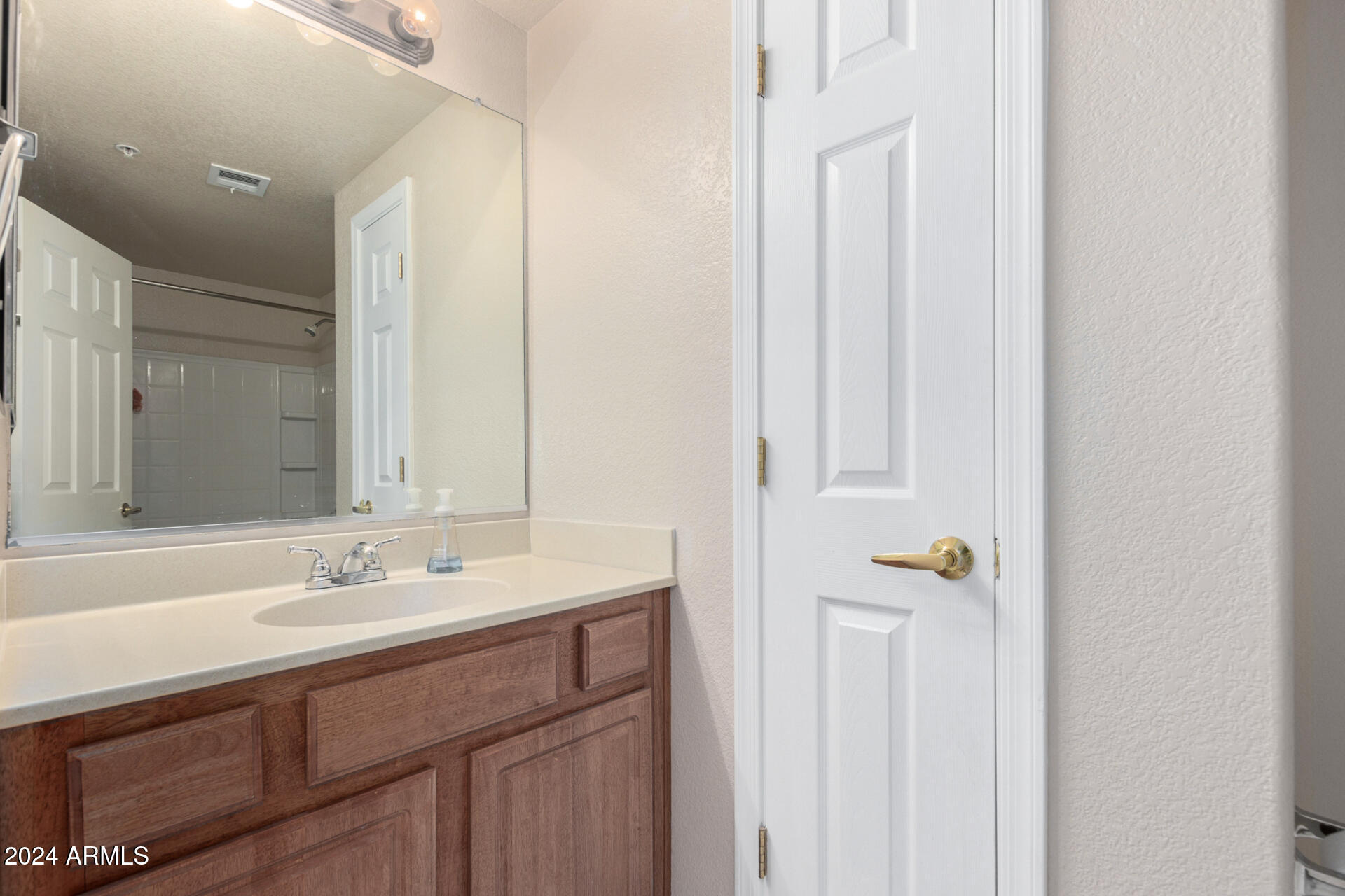 18250 North Cave Creek Road, Unit 163 Phoenix, AZ 85032 - Photo 19 of 32 a bathroom with a sink and a mirror