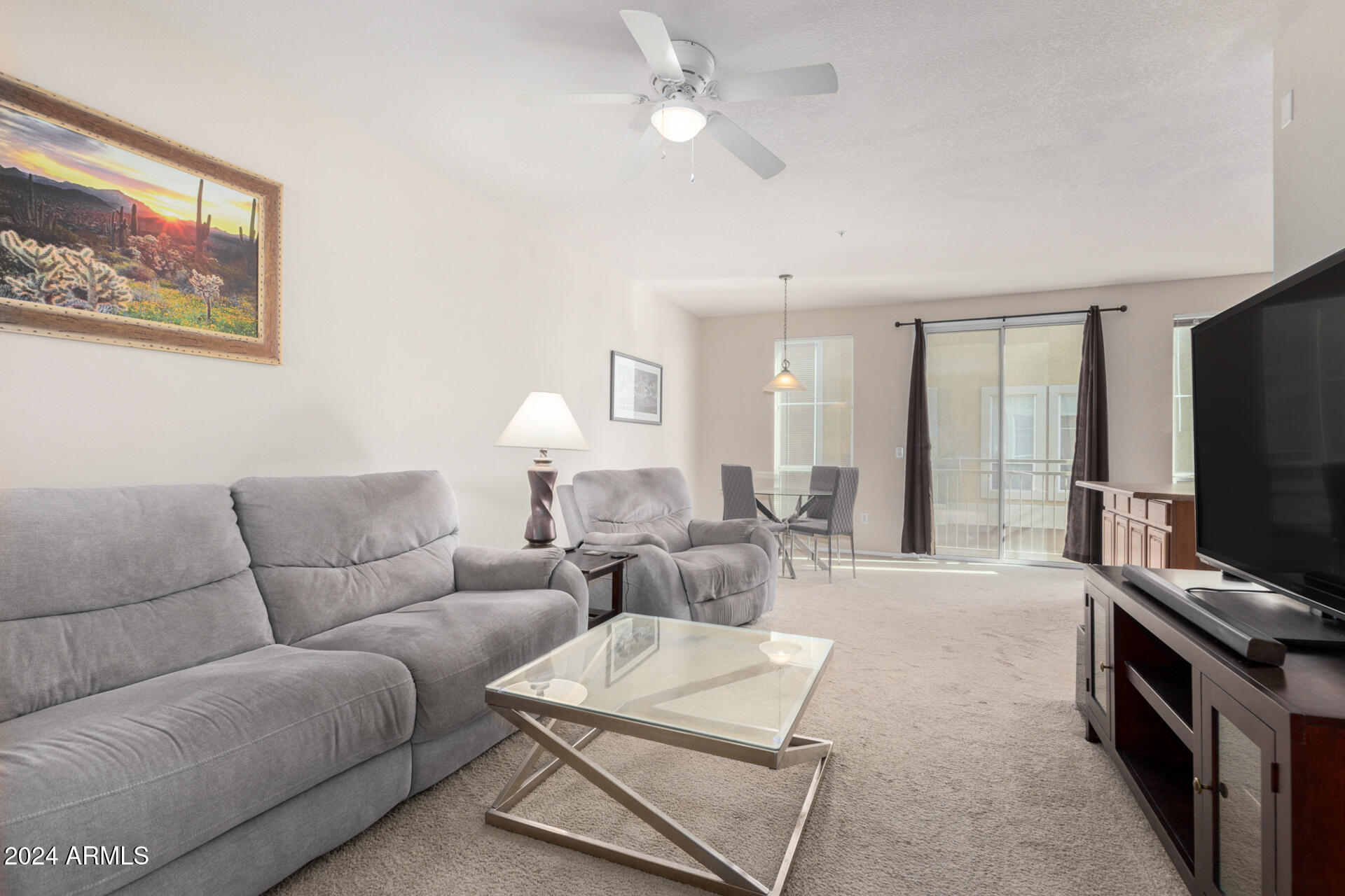 18250 North Cave Creek Road, Unit 163 Phoenix, AZ 85032 - Photo 7 of 32 a living room with furniture a ceiling fan and a flat screen tv