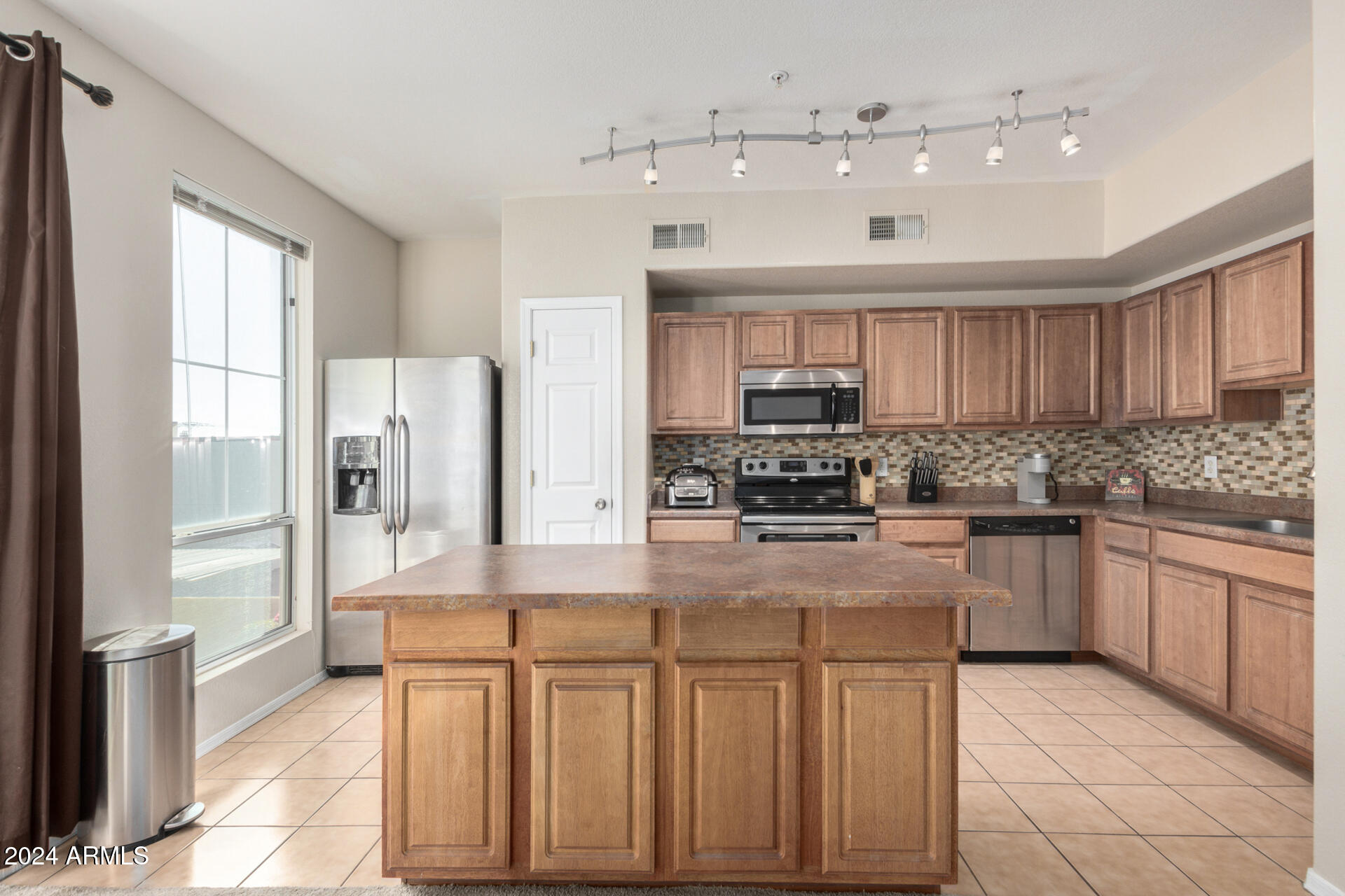 18250 North Cave Creek Road, Unit 163 Phoenix, AZ 85032 - Photo 10 of 32 a kitchen with stainless steel appliances granite countertop a stove and cabinets