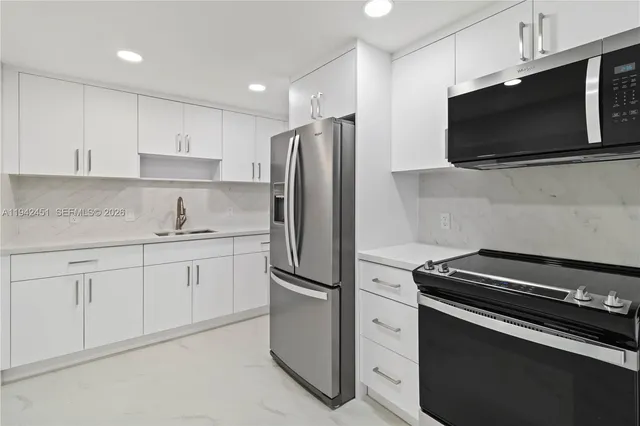 a kitchen with stainless steel appliances a refrigerator stove and microwave
