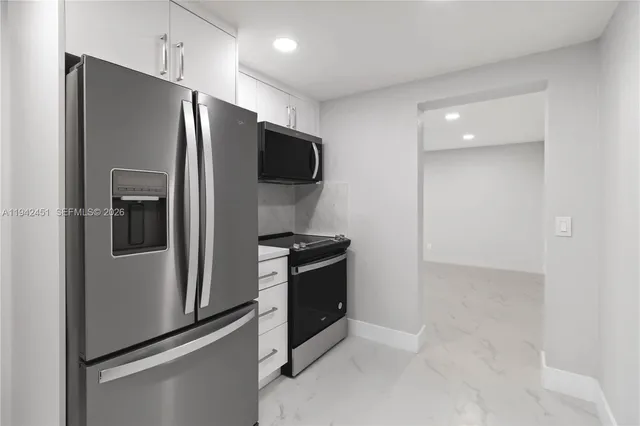 a kitchen with stainless steel appliances a refrigerator and a stove top oven