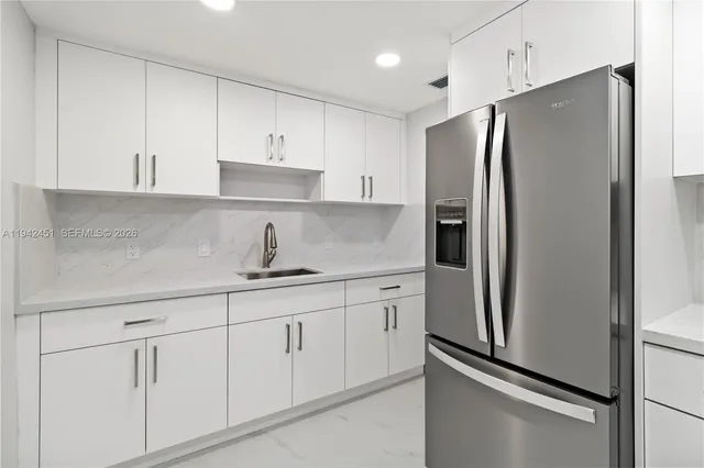 a kitchen with stainless steel appliances a refrigerator and cabinets