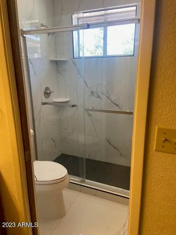 a bathroom with a glass door shower