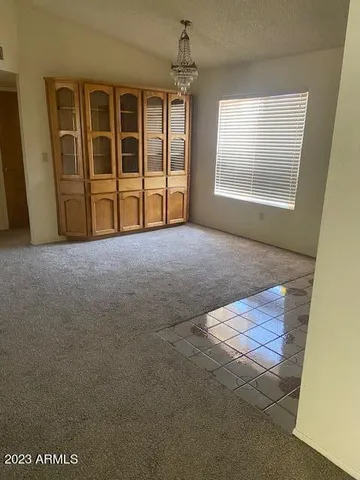 an empty room with windows and closet
