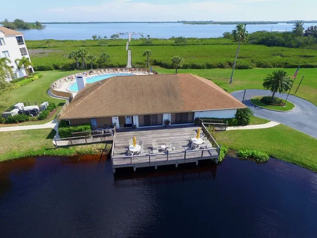 an aerial view of a house with swimming pool and outdoor seating