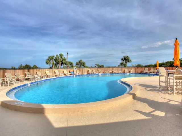 a view of a swimming pool with an outdoor seating