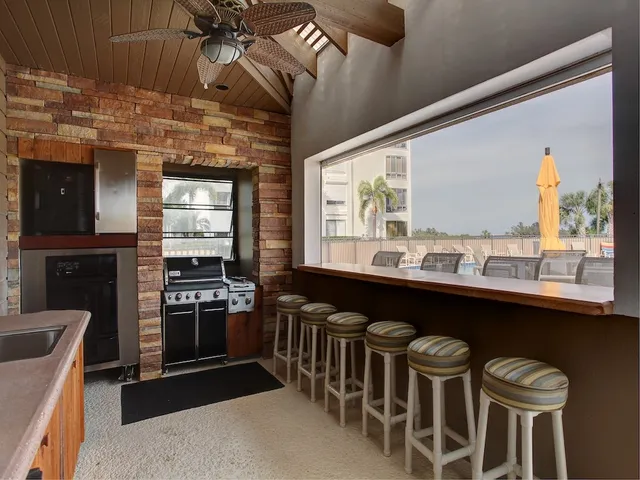 a kitchen with a stove a sink and a microwave