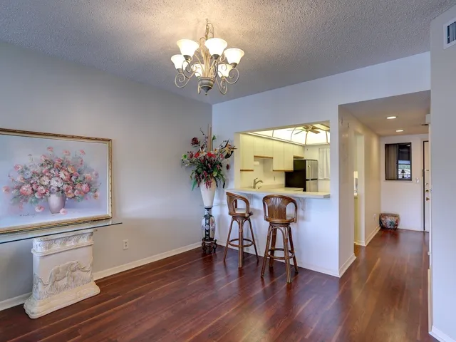 a view of a room with furniture and wooden floor
