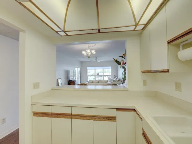 a view of a kitchen with a sink and cabinets