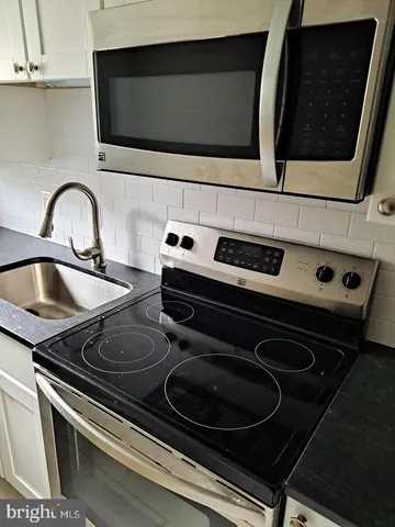 a kitchen with a stove and a microwave