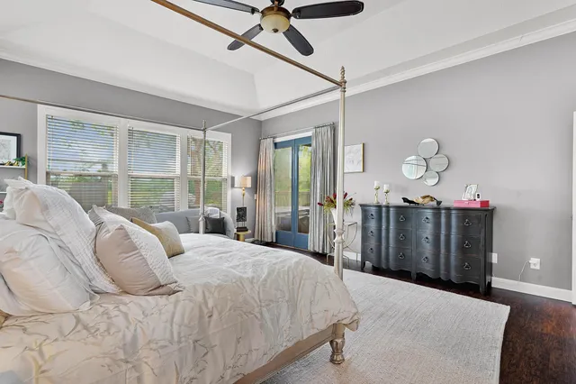 a spacious bedroom with a bed a couch and a chandelier