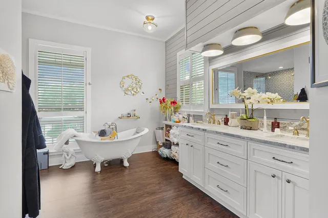 a bedroom with a bed dresser and a window