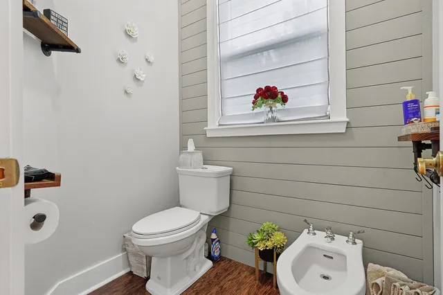 a bathroom with a toilet sink and mirror
