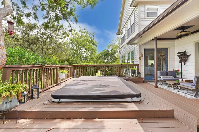 a view of a wooden floor and a small yard in front of a house