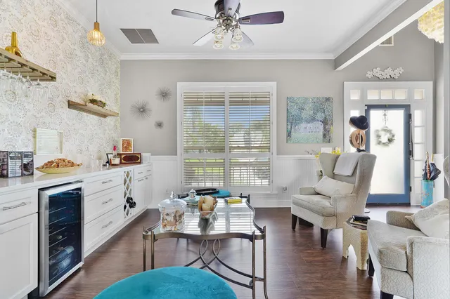 a living room with furniture a fireplace and a chandelier