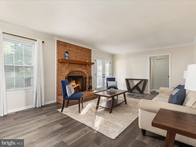 a living room with furniture a fireplace and a table