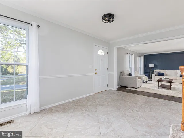 a view of a livingroom with workspace and a window