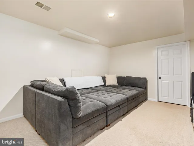 a living room with furniture and a bed