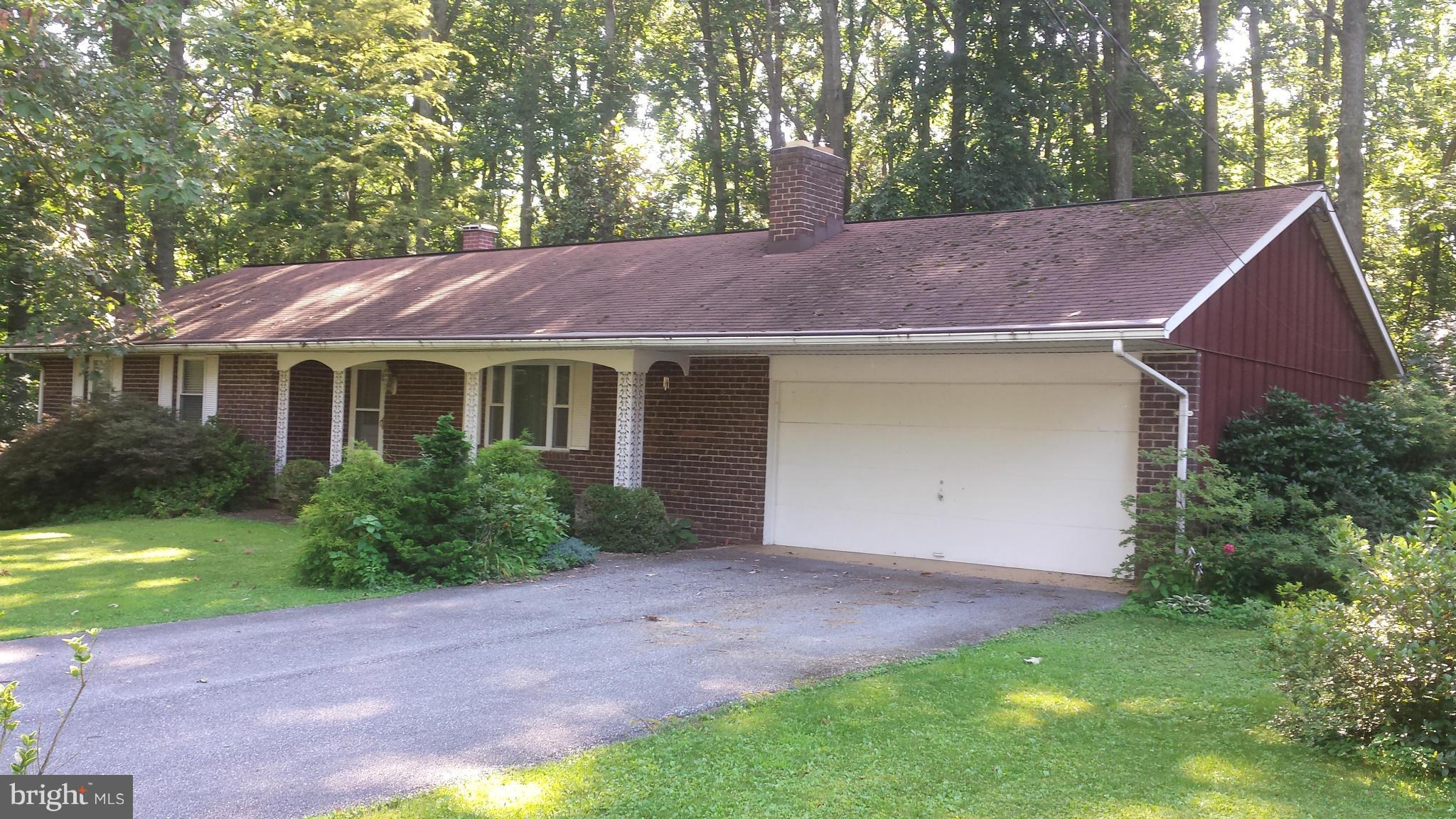 1601 Exeter Road Westminster, MD 21157 - Photo 1 of 19 a front view of a house with a garden and yard
