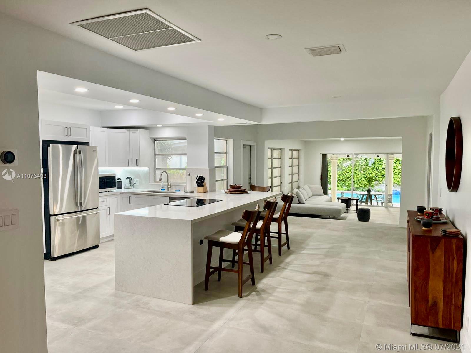 a large kitchen with a table and chairs in it