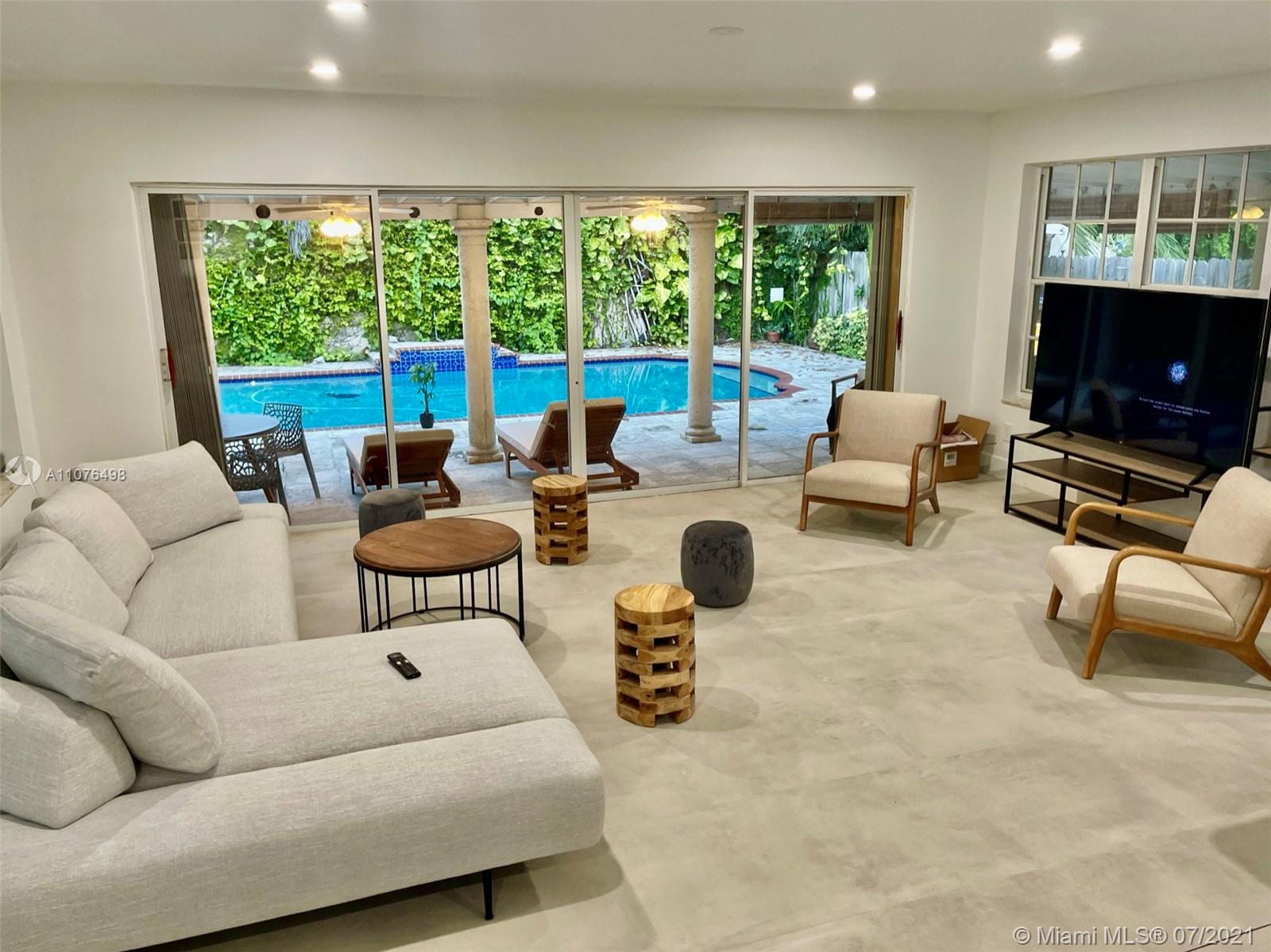341 Southwest 21st Road Miami, FL 33129 - Photo 4 of 14 a living room with furniture and a flat screen tv