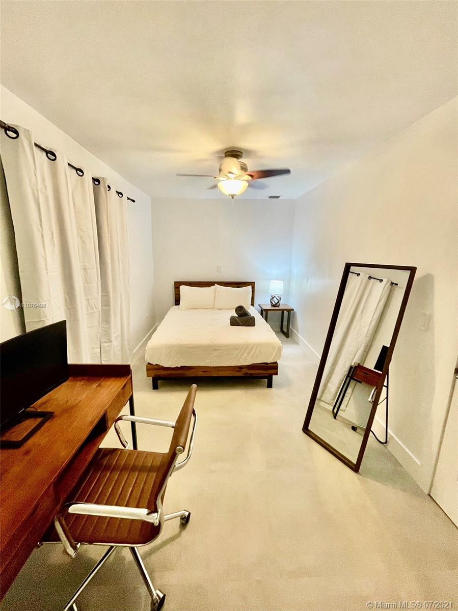 341 Southwest 21st Road Miami, FL 33129 - Photo 7 of 14 a bedroom with a bed and a chandelier