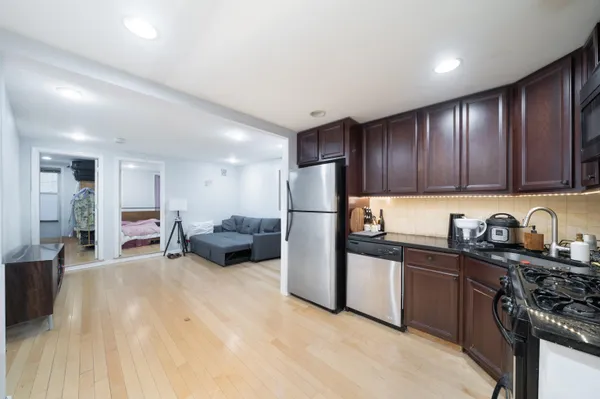 a kitchen with sink a refrigerator and cabinets