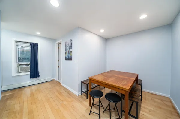 a view of a room with furniture and wooden floor