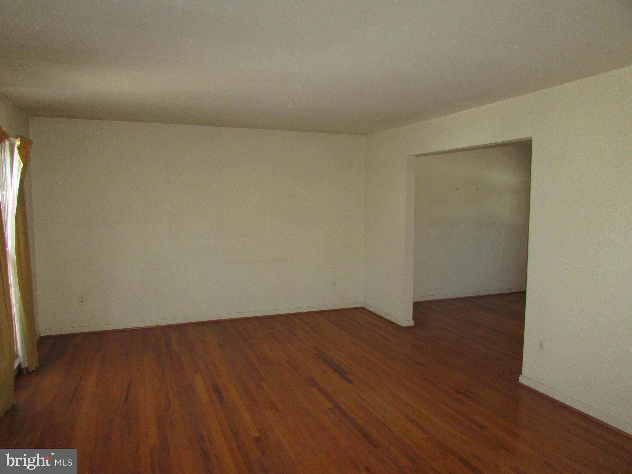 14221 Cantrell Road Silver Spring, MD 20905 - Photo 2 of 16 an empty room with wooden floor and windows