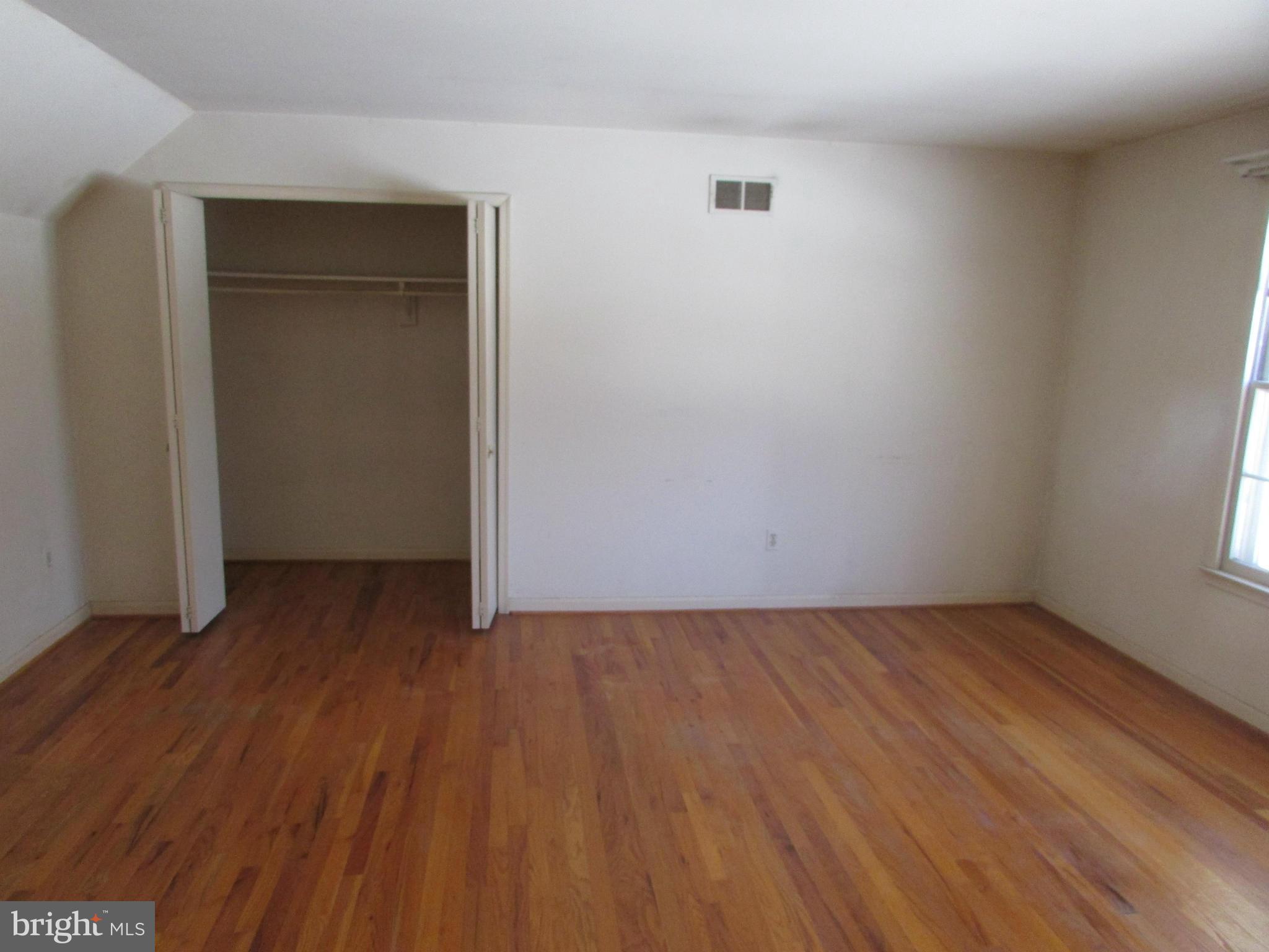 14221 Cantrell Road Silver Spring, MD 20905 - Photo 11 of 16 a view of an empty room with wooden floor and closet