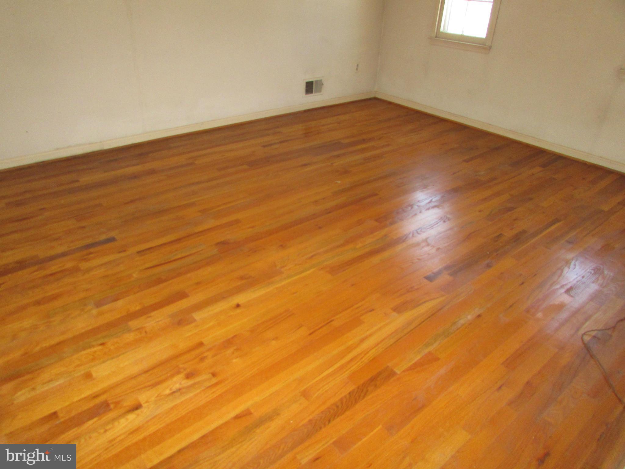 14221 Cantrell Road Silver Spring, MD 20905 - Photo 13 of 16 a view of empty room with wooden floor and fan