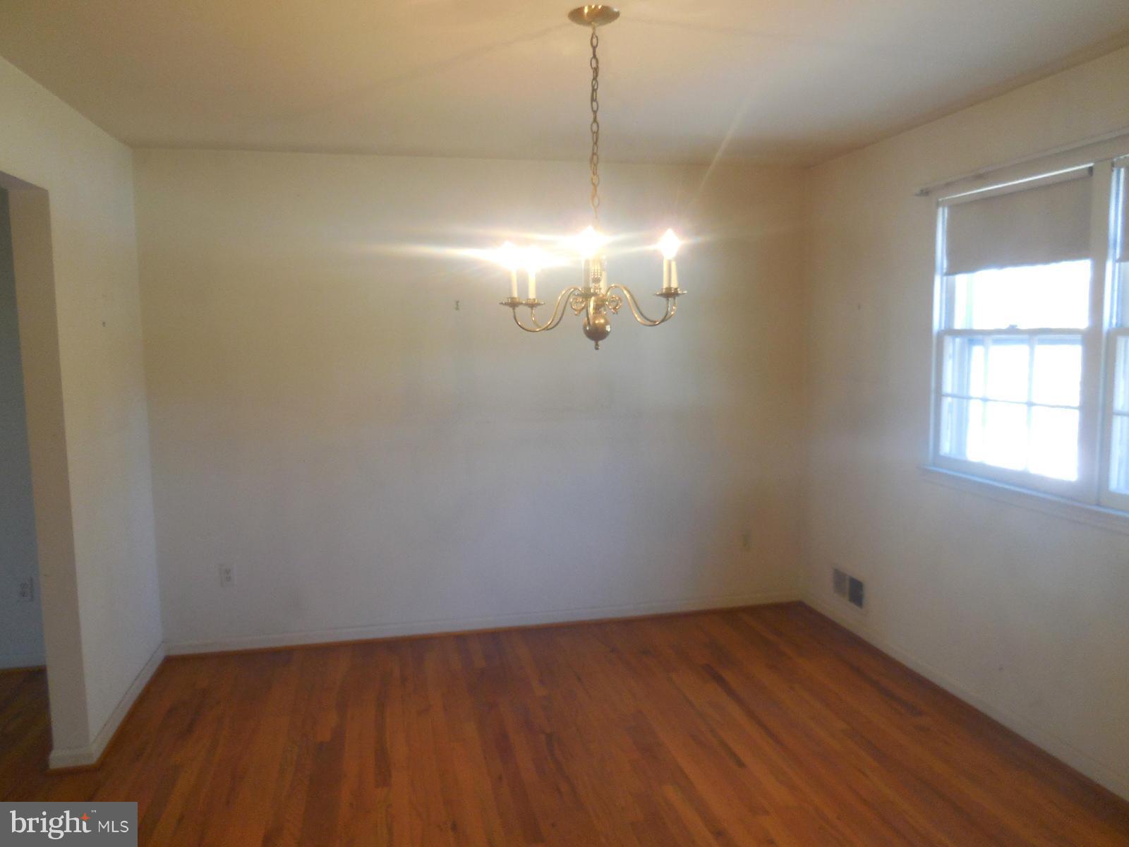 14221 Cantrell Road Silver Spring, MD 20905 - Photo 5 of 16 a view of a room with wooden floor and windows