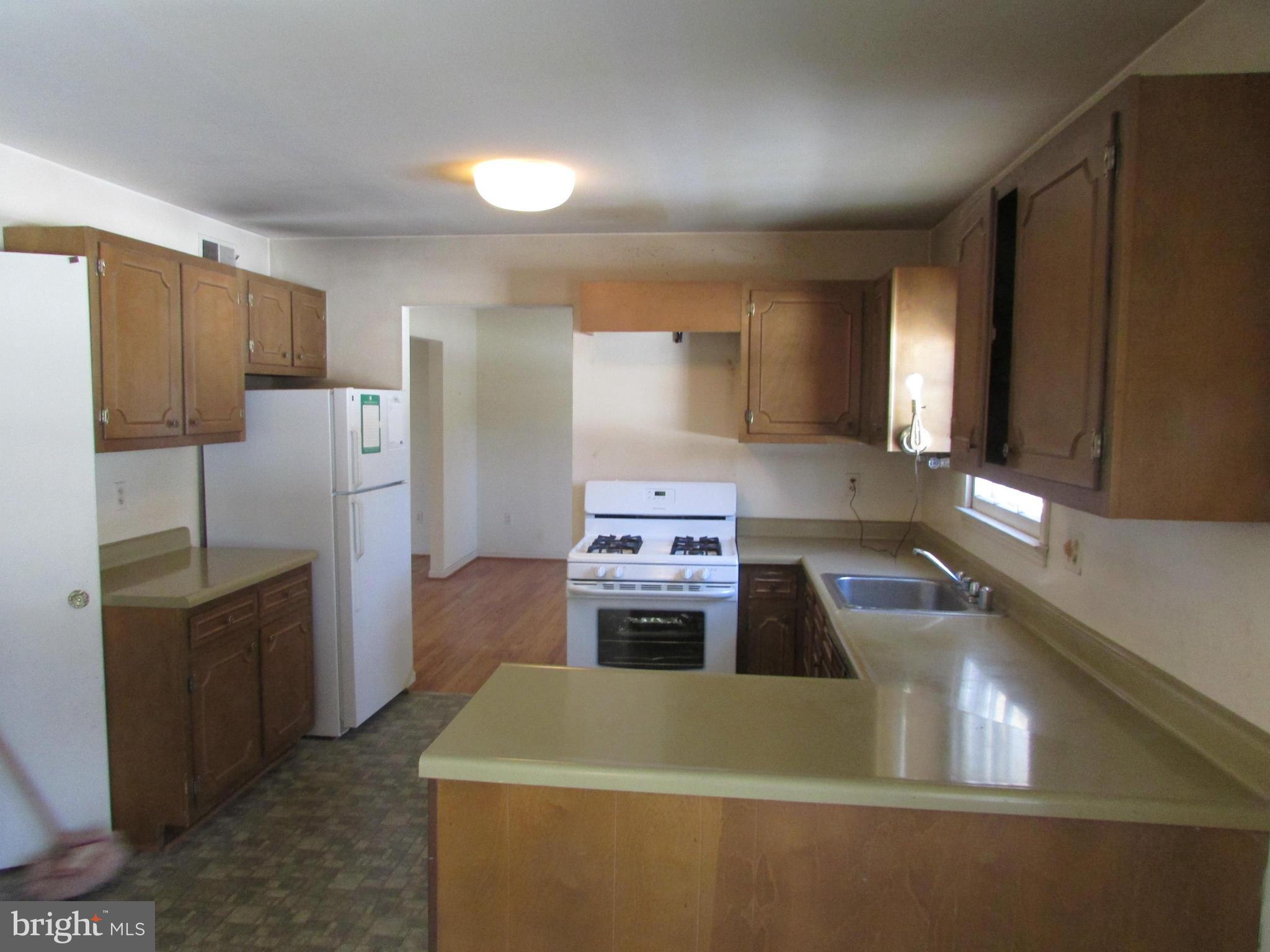 14221 Cantrell Road Silver Spring, MD 20905 - Photo 6 of 16 a kitchen with a refrigerator sink and stove