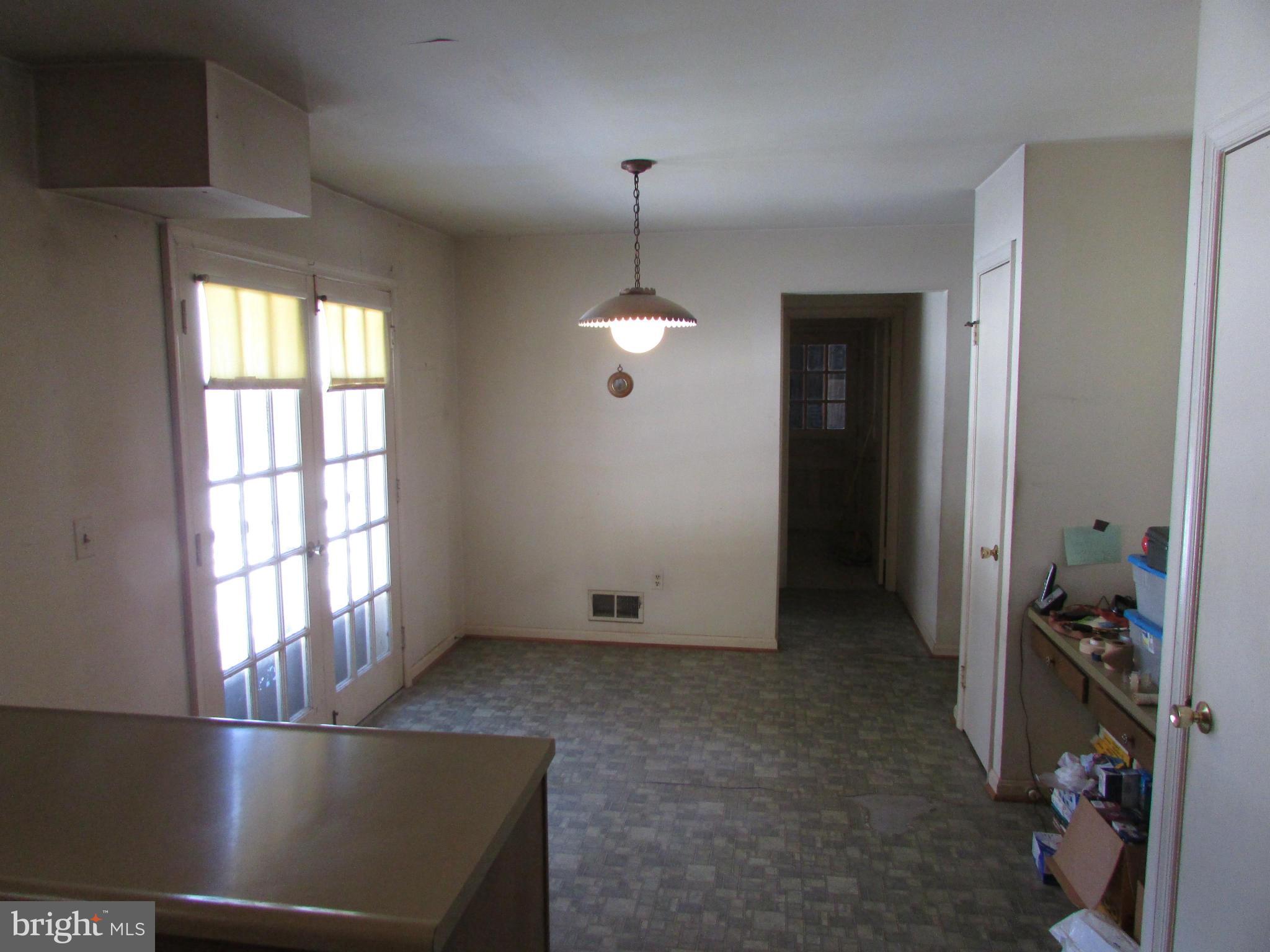 14221 Cantrell Road Silver Spring, MD 20905 - Photo 8 of 16 a view of empty room with wooden floor and fan