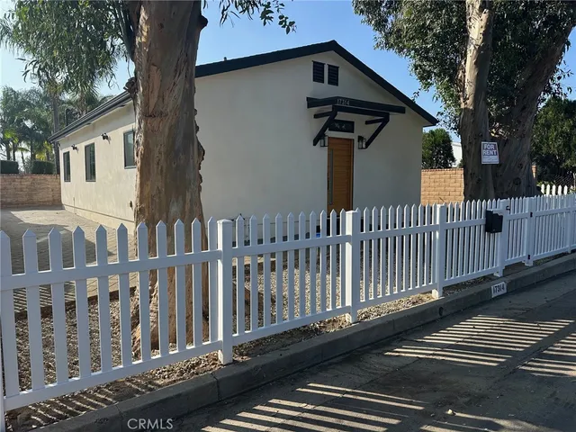 a view of a wooden house and a yard