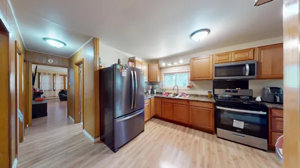 a kitchen with stainless steel appliances granite countertop a refrigerator stove and sink