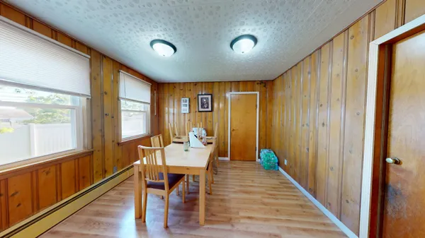 a dining room with furniture wooden floor and windows