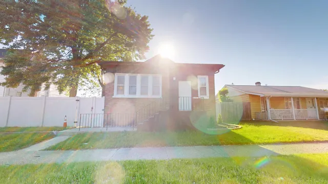 a view of a house with a yard and sitting area