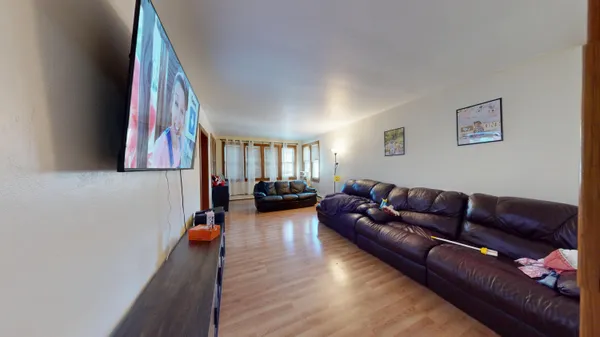 a living room with furniture and a wall painting