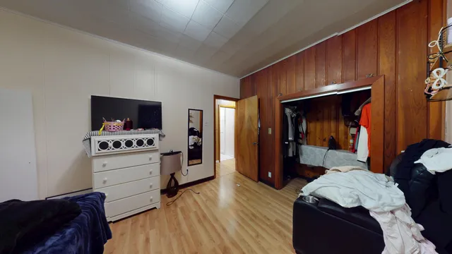 a bedroom with furniture and flat screen tv