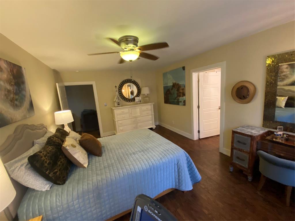 1079 Union Hill Road Mineral Wells, TX 76067 - Photo 30 of 40 a bedroom with a bed and a chandelier